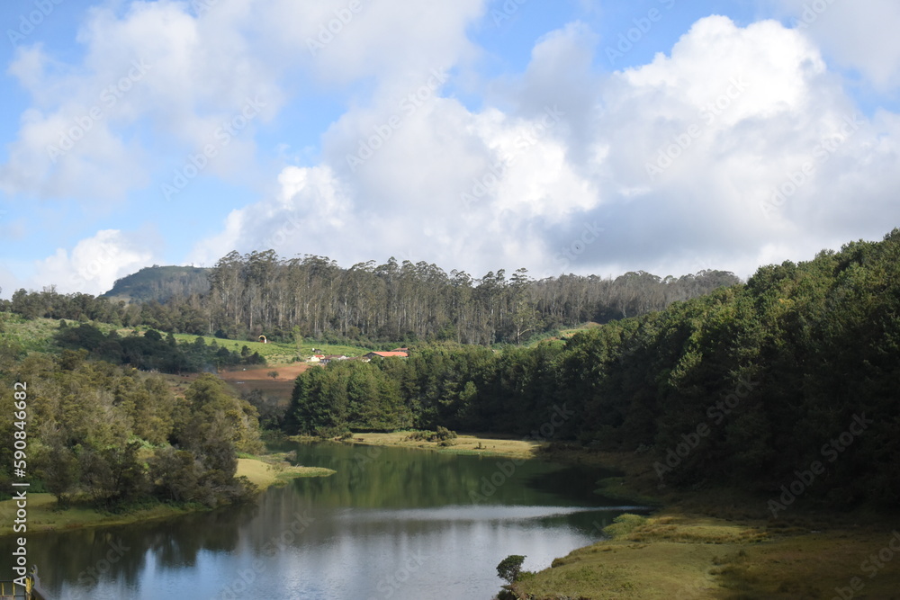 Fototapeta premium Beautiful river with cloudy sky and greenery all around