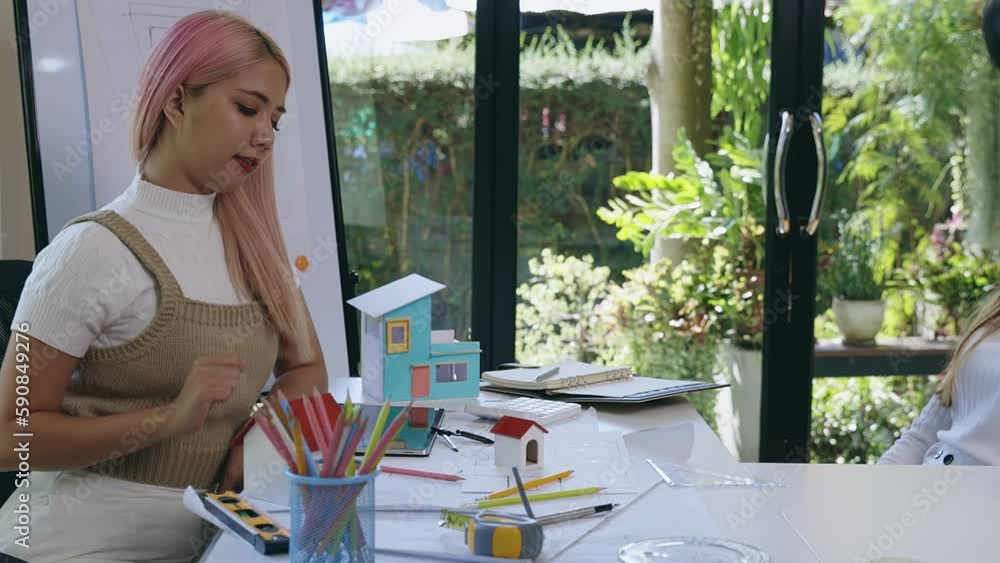Architect woman model house on office desk with shop drawing paper in ...