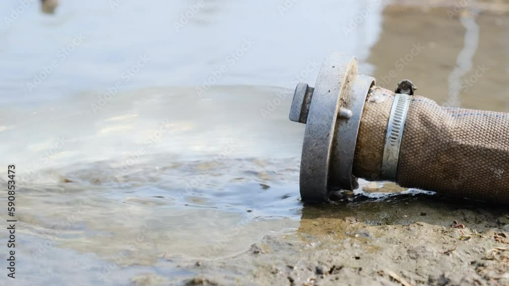 Wastewater sewage pipe dumps the dirty contaminated water into the river. Water pollution, environment contamination concept. Wastewater sewage pipe dumps the dirty contaminated water into the river. Water pollution, environment contamination concept.