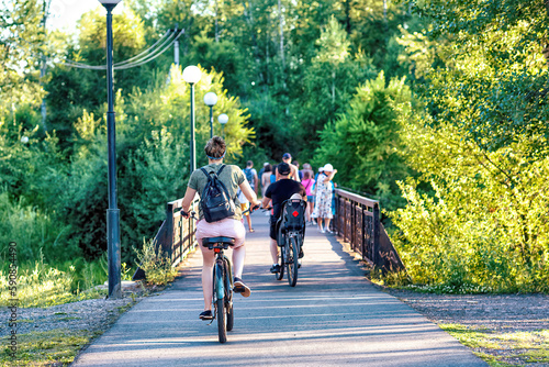 Wallpaper Mural A young woman riding a bicycle in a park in summer. Torontodigital.ca