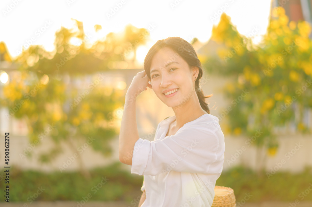 Portrait young beautiful asian woman with happy smile around outdoor park in sunny summer day Portrait young beautiful asian woman with happy smile around outdoor park in sunny summer day