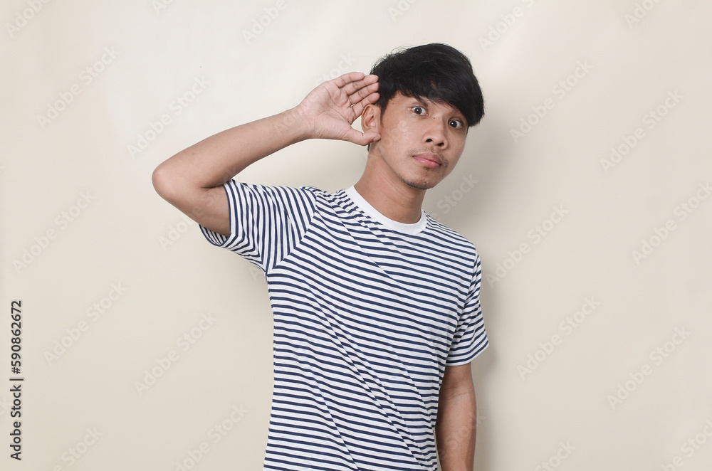 Obraz premium Young Asian man showing can not hear gestures