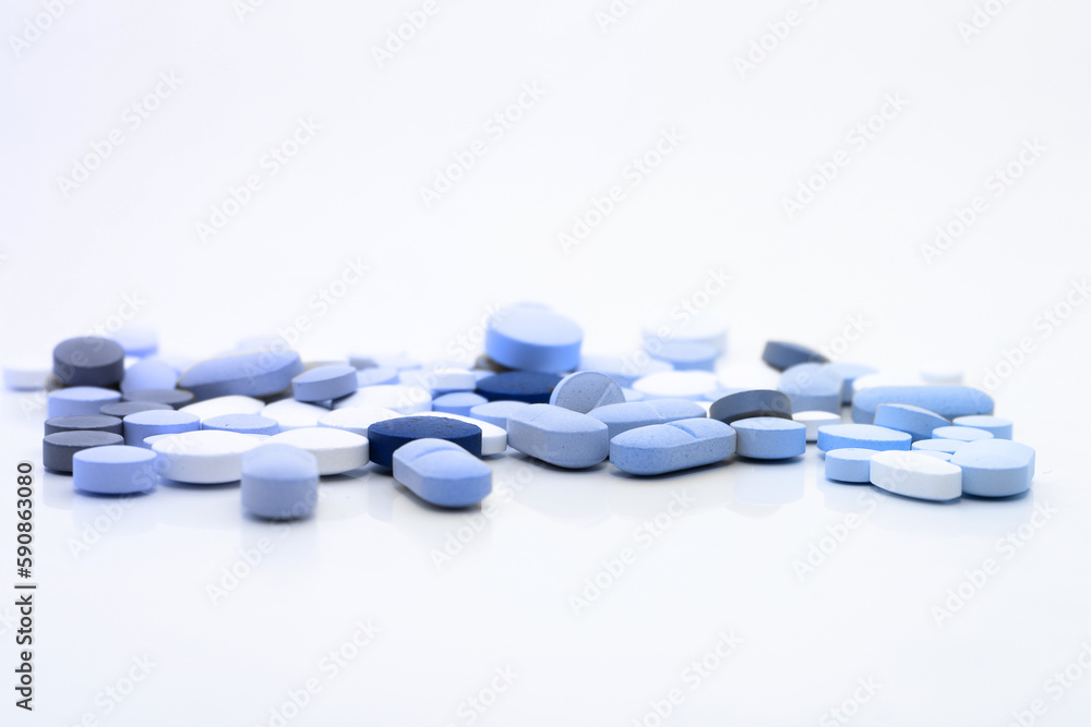 Assorted pills on a neutral background with light blue colors. Concept of pills used for male erection.