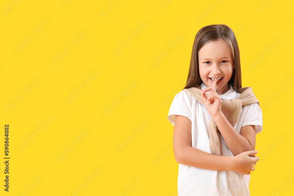 Little girl biting nails on yellow background Little girl biting nails on yellow background