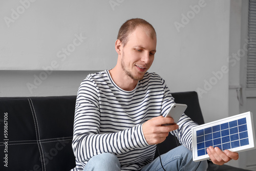 Young man using mobile phon...