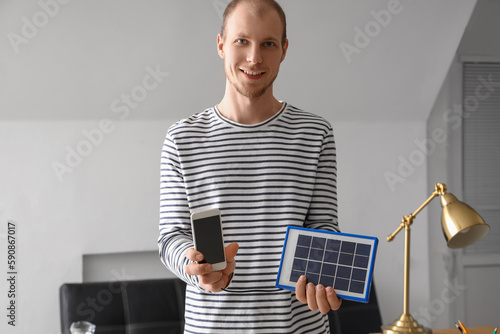 Young man with portable sol...