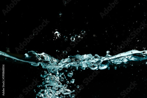 Water surface with bubbles on black background.