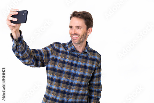 Adult hipster male model posing taking a selfie and smiling © Jordi