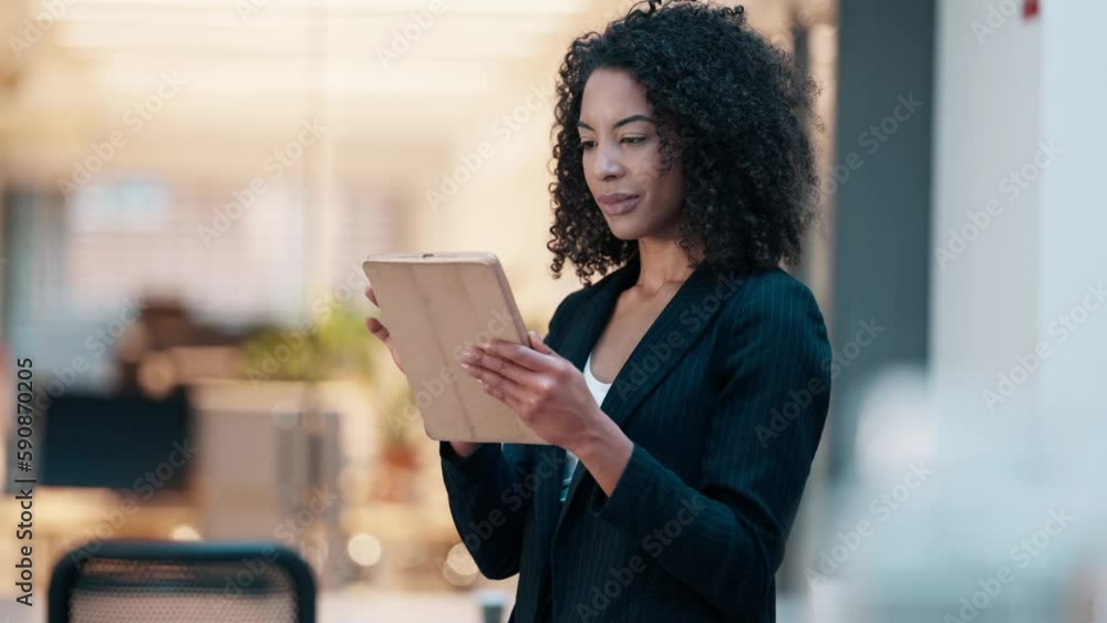 Video of elegant and smart woman working with digital tablet while standing in a modern office Video of elegant and smart woman working with digital tablet while standing in a modern office