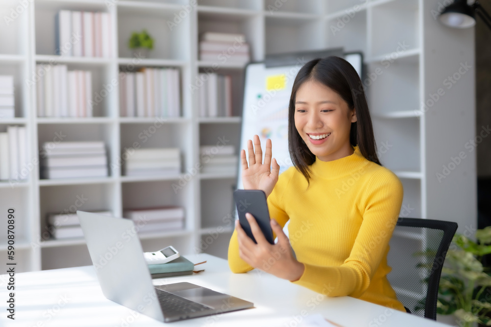 Happy Asian woman making video call via smart phone talking with friends. Happy Asian woman making video call via smart phone talking with friends.