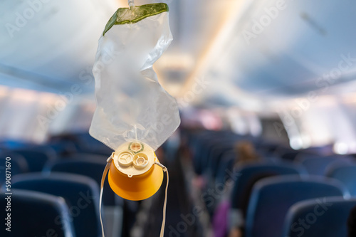 oxygen mask drop from the ceiling compartment on airplane.. photo