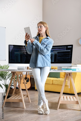 Young female programmer usi...