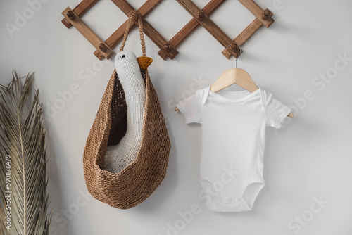 Minimalist white baby short sleeve bodysuit mockup for presentation cute sublimation designs. Minimalistic photos of romper for toddlers in scandinavian boho interior with minimalistic decoration photo