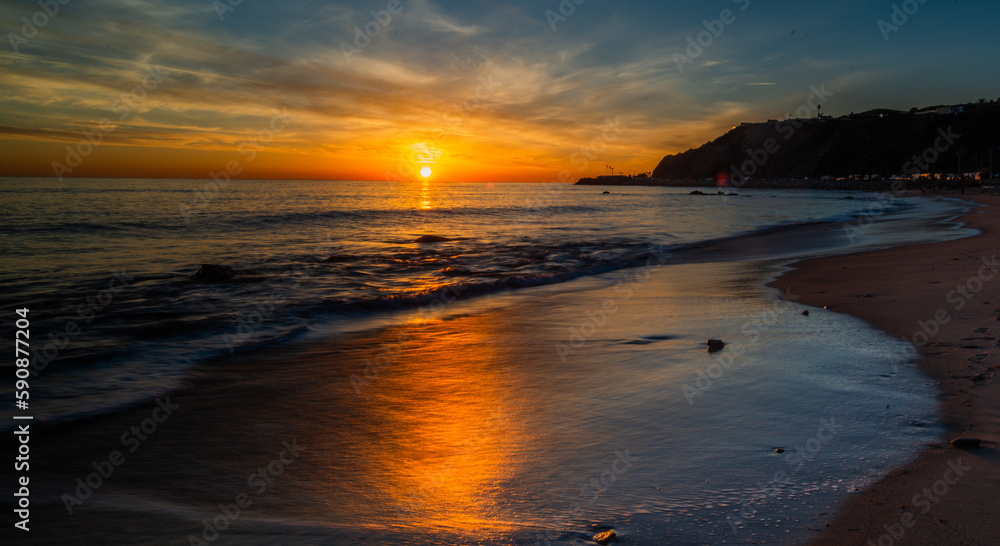 Fototapeta premium Evening Stroll: Sunset at a beach in Southern California