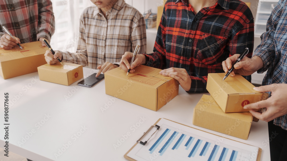 Team of smes warehouse checking email and writing on parcel cardboard box, Small business entrepreneur, SME, freelance online sellers, influencer and the team behind the work. Team of smes warehouse checking email and writing on parcel cardboard box, Small business entrepreneur, SME, freelance online sellers, influencer and the team behind the work.