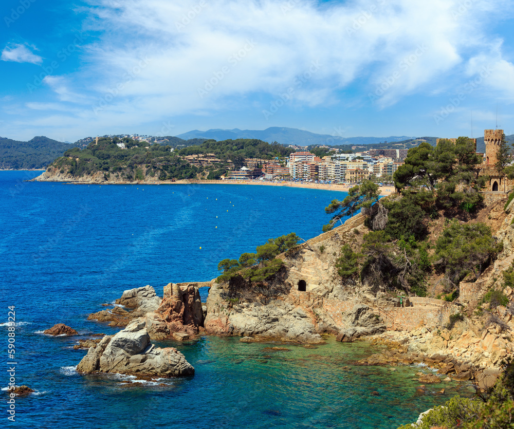 Summer sea rocky coast view with Castle of Sant Joan (Sa Caleta beach, Lloret de Mar town, Catalonia, Spain). People are unrecognizable.