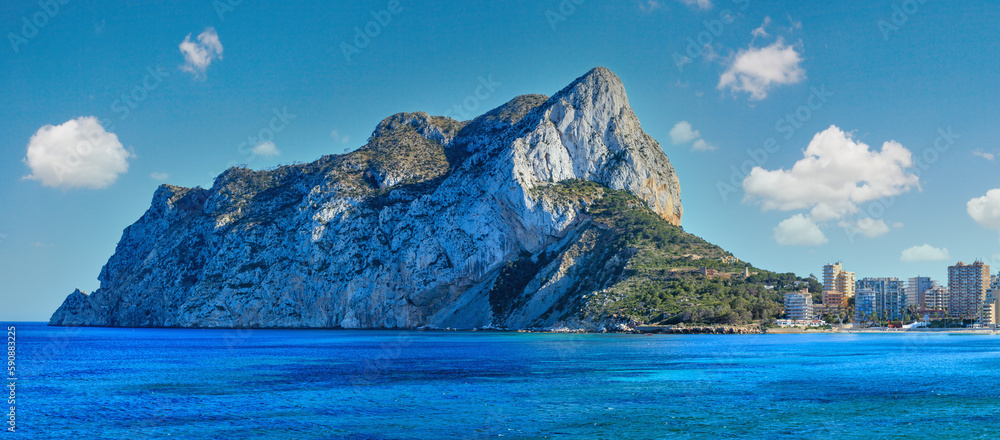 Calp town summer coastline at Costa Blanca (Valencia), Spain. People are unrecognizable.