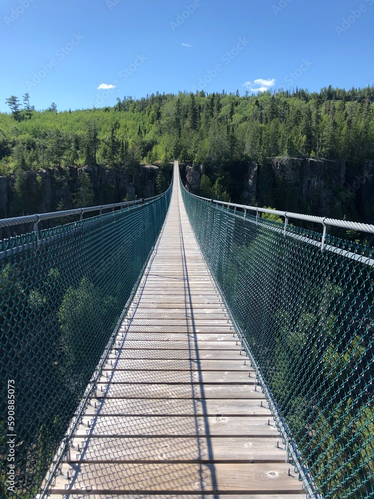 Suspension bridge in Thunder Bay Ontario over a rocky forest