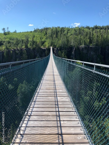 Fototapeta Naklejka Na Ścianę i Meble -  Suspension bridge in Thunder Bay Ontario over a rocky forest
