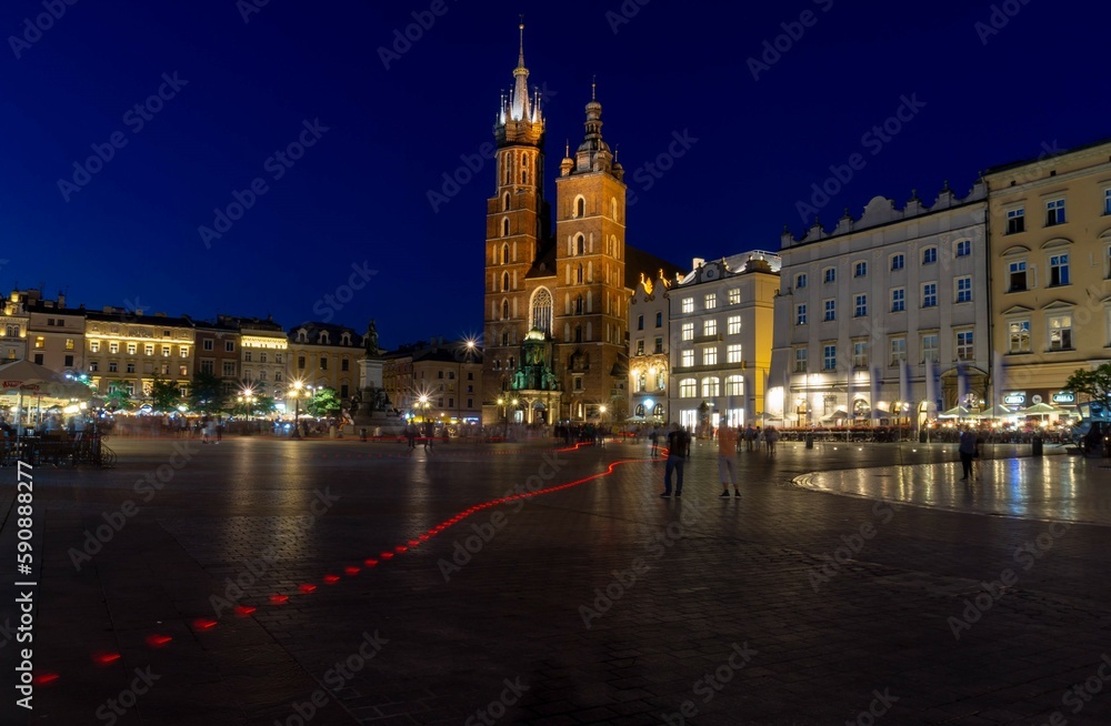 Krakow main square church at night with people in ghost effect