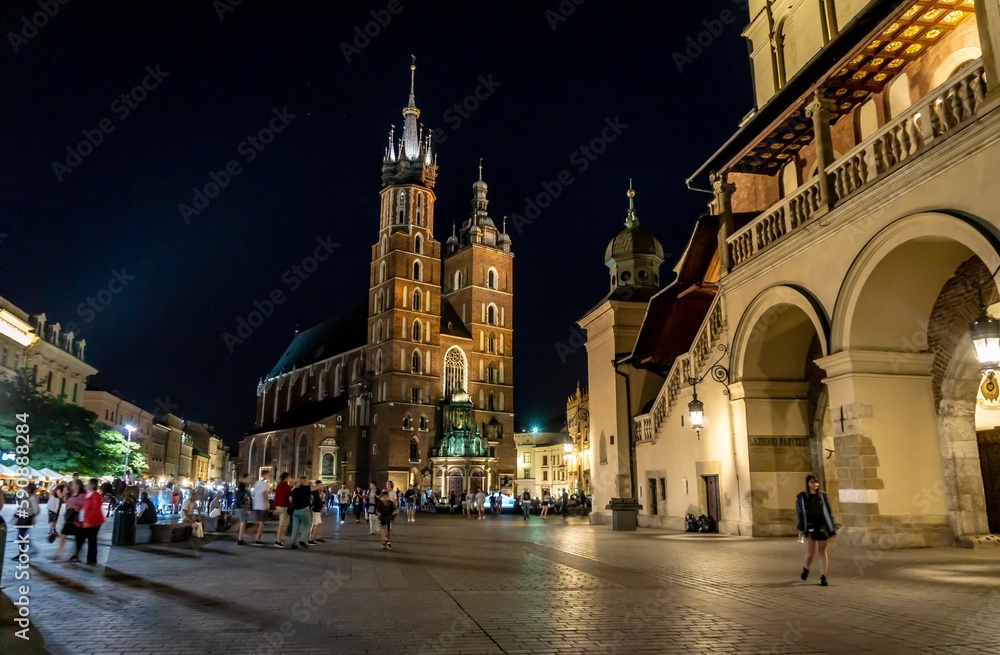Krakow main square church at night with people in ghost effect
