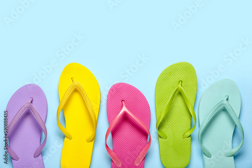 Colorful flip-flops on blue background
