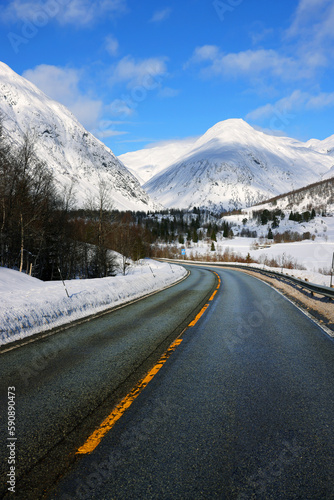 Winter landscape with snow covered mountains and an icy road in Norway, Europe