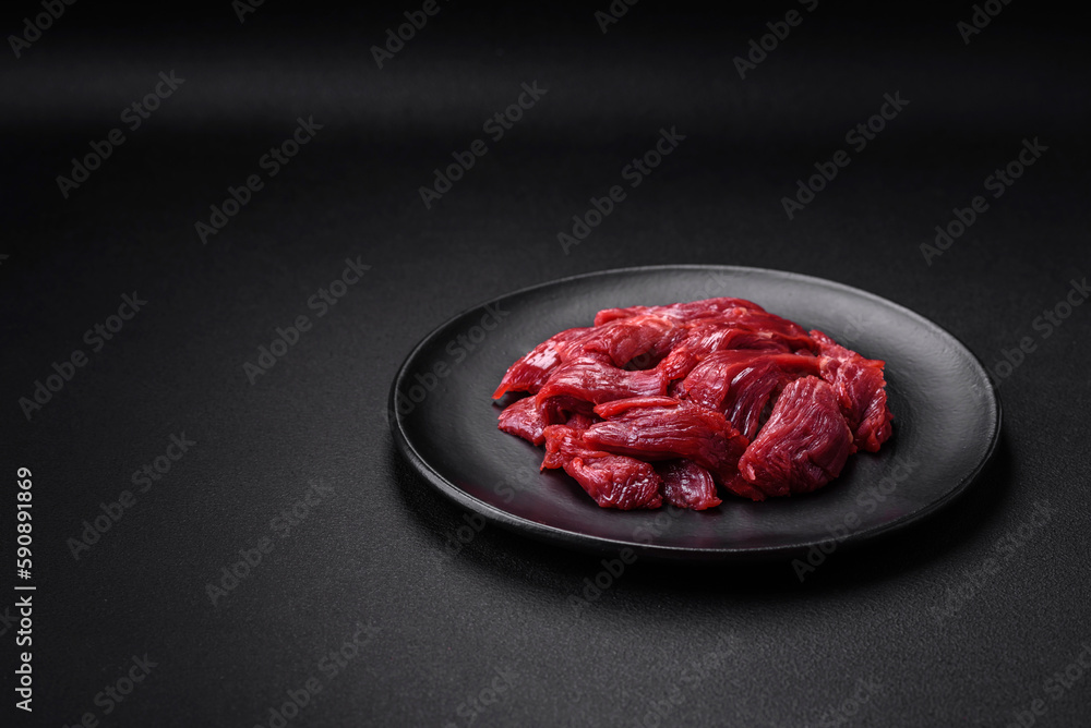 Fresh raw beef with salt, spices and herbs Fresh raw beef with salt, spices and herbs