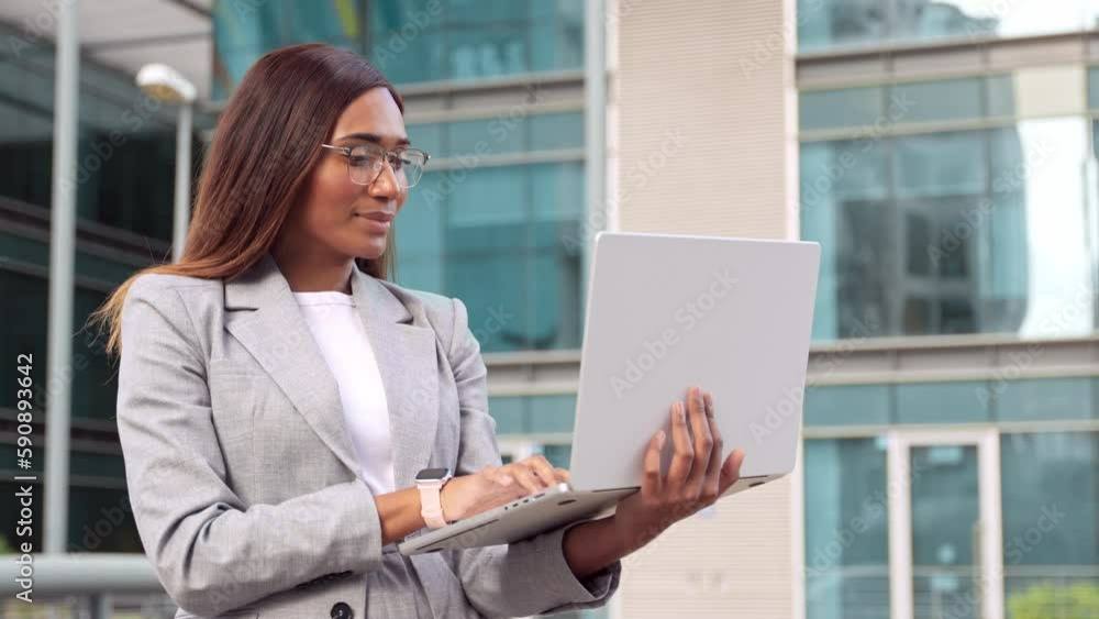 Middle age business woman using touchscreen pc laptop standing near office center. African American mature female businesswoman, successful entrepreneur using app gadget standing at street outdoors. Middle age business woman using touchscreen pc laptop standing near office center. African American mature female businesswoman, successful entrepreneur using app gadget standing at street outdoors.
