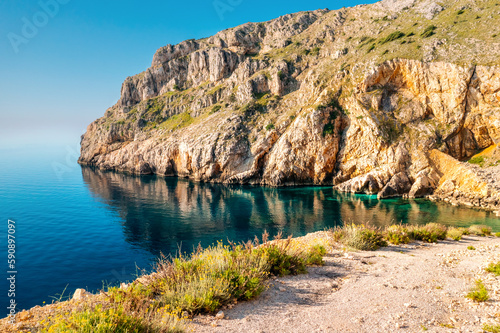 Calm lagoon and wild beach with azure water on a sunny day. Island Cres, Croatian coast, Europe.