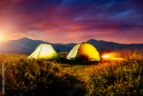 The two tents in the foreground is highlighted from the inside. Carpathian mountains  Ukraine  Europe.
