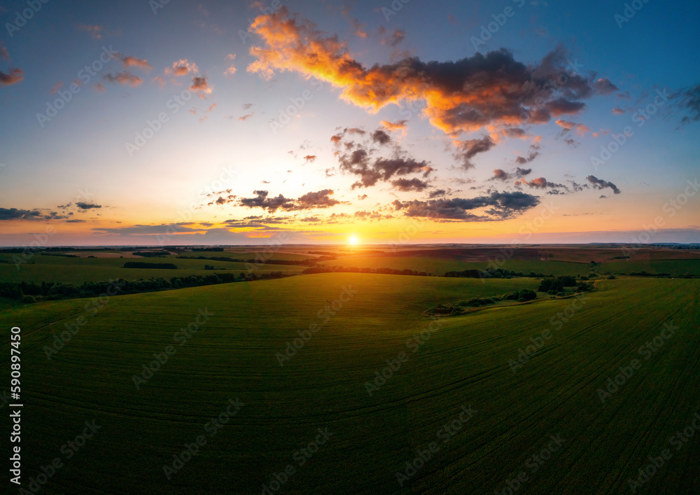 Breathtaking sunset over farmland in summer taken from a drone.