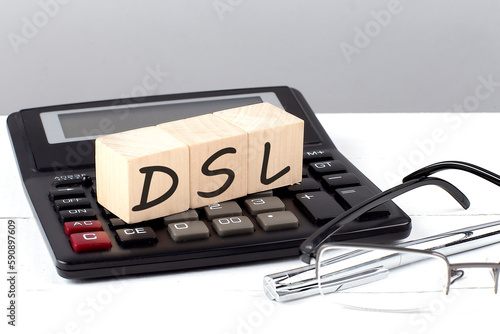 DSL concept on wooden cubes on calculator on white background