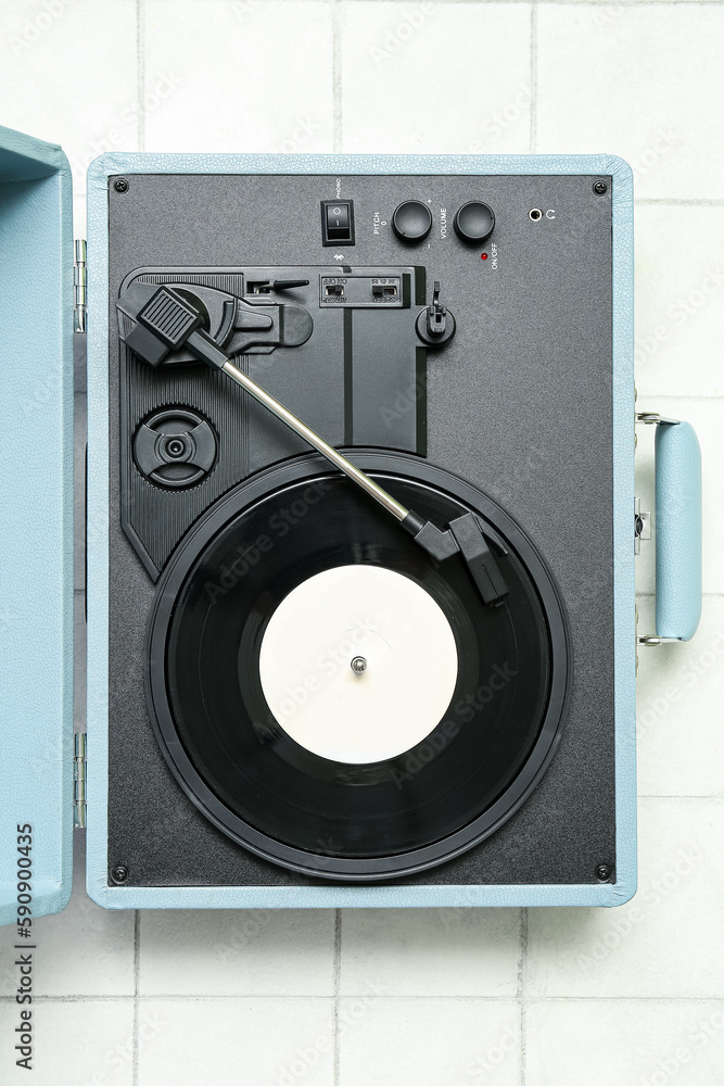 Fototapeta premium Record player with vinyl disk on white tile background