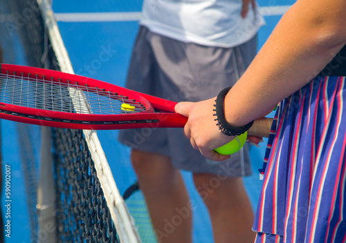 Close-up of a tennis player's hand holding a tennis ball and racket  © Павел Мещеряков
