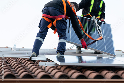 Canvastavla Pareja de técnicos instalando placas solares en una vivienda. 10