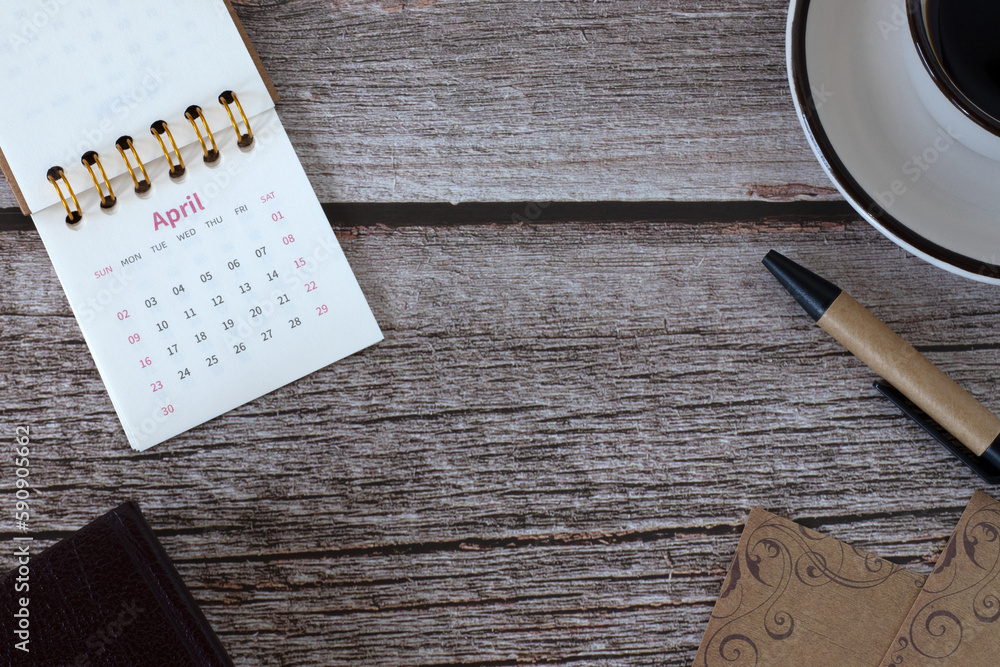 Φωτογραφία Spiral calendar, holy bible book, vintage paper, pen, and a cup of coffee on wooden table