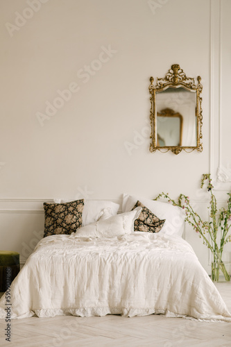 Large white bedroom with large windows, beautiful bright interior