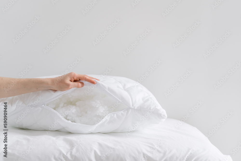 woman showing cushion with cotton wool filling at home woman showing cushion with cotton wool filling at home