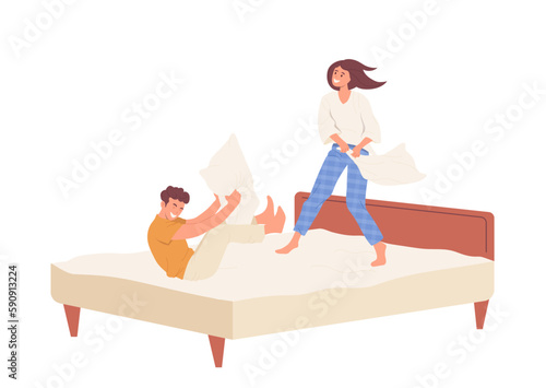 Happy man and woman fighting pillows on bed, playful family couple having fun together at home