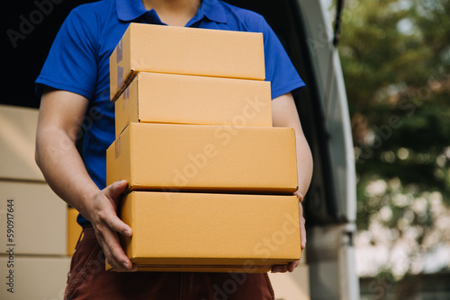 Startup small business entrepreneur of freelance Asian woman using a laptop with box Cheerful success Asian woman her hand lifts up online marketing packaging box and delivery SME idea concept