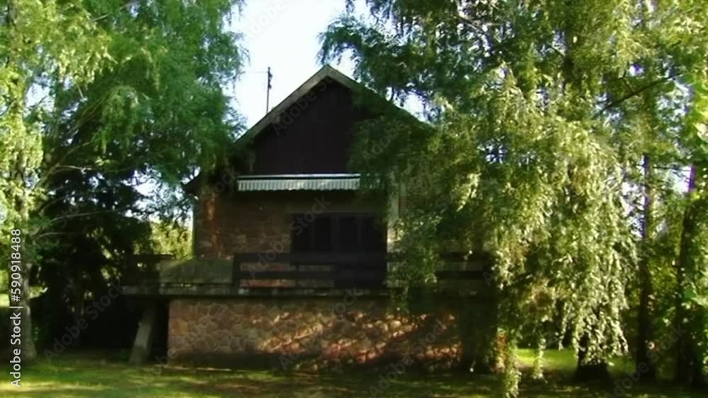 Empty, eerie house surrounded by green trees. Empty, eerie house surrounded by green trees.