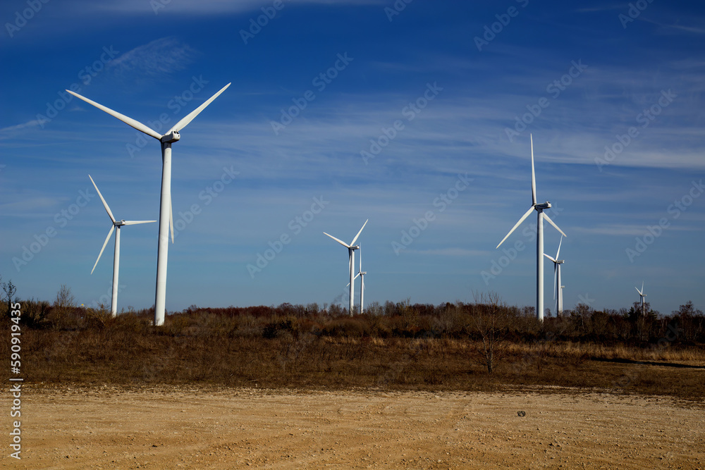  Wind turbines against blue sky background.