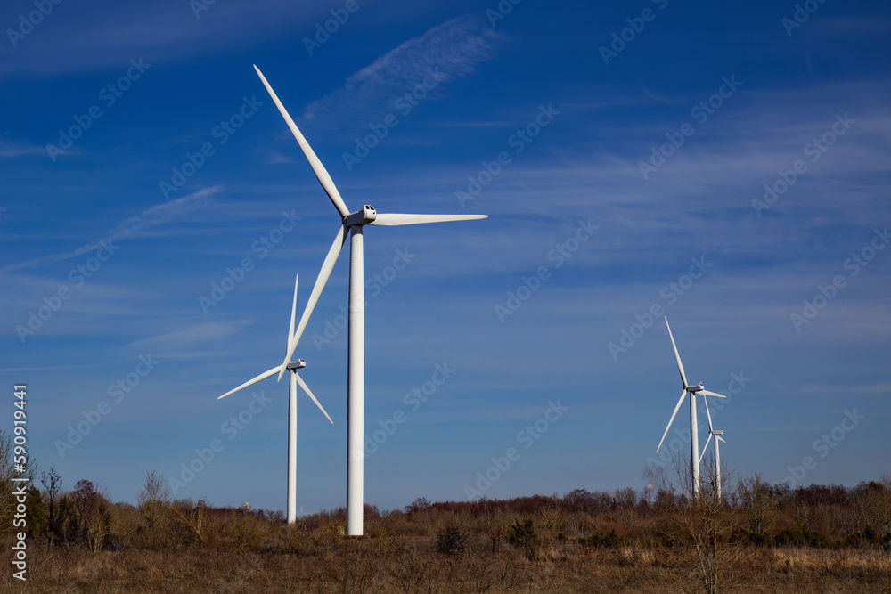  Wind turbines against blue sky background.