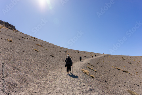 Group of hikers climbing a mountain, Tourists touring the national park Nevado de Colima, an ancient extinct volcano.