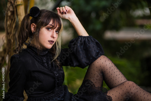 gothic lolita victorian cosplay costume. Hispanic young woman cheerful portrait outdoor background