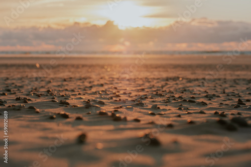 Sunset in the sea with unmelted ice floes that look like little caps. Clouds like a mountain range above the horizon and a blurred sun in the background. Copy space. Background for quotes. photo