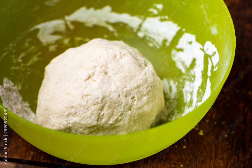 Dough ball in plastic bowl. Preparation of yeast dough for making bread, pizza bases. Dough ball in plastic bowl. Preparation of yeast dough for making bread, pizza bases.
