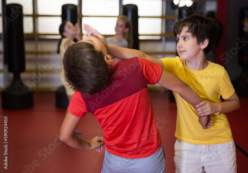 Two boys in sparring practice self defense technique in the gym © JackF