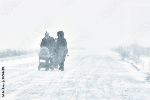 A snowstorm. People walk down the street during a snowstorm. Heavy snowfall. against the background of a cold urban landscape.